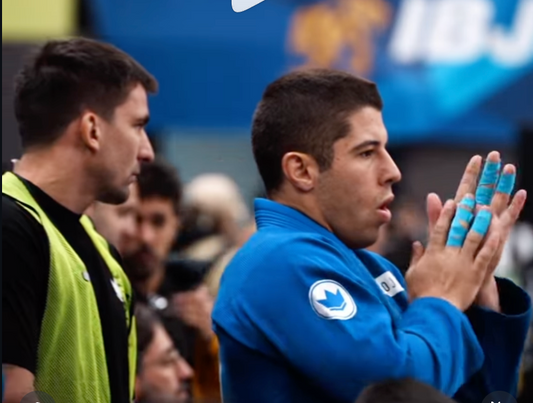 Jiu Jitsu athlete Tainan Dalpra with taped fingers preparing for competition – best BJJ finger tape for grip strength