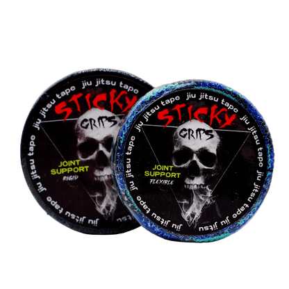 Two containers of Sticky Grips jiu jitsu tape with skull design on a light gray background