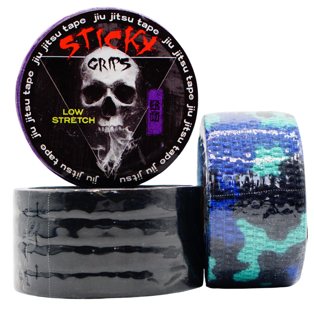 Sticky Grips jiu jitsu tape with a skull design on the packaging, surrounded by rolls of tape.