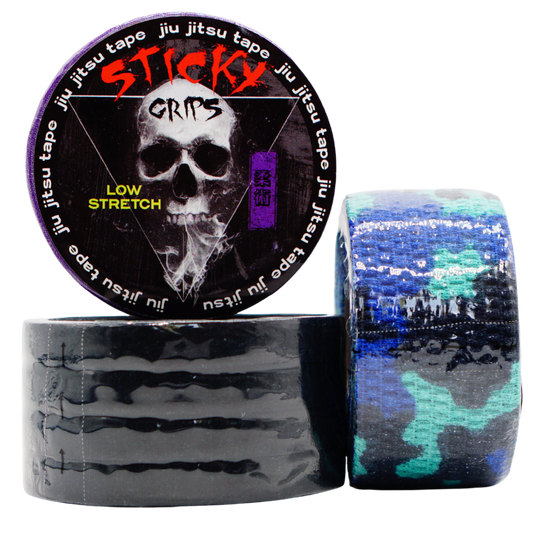 Sticky Grips jiu jitsu tape with a skull design on the packaging, surrounded by rolls of tape.