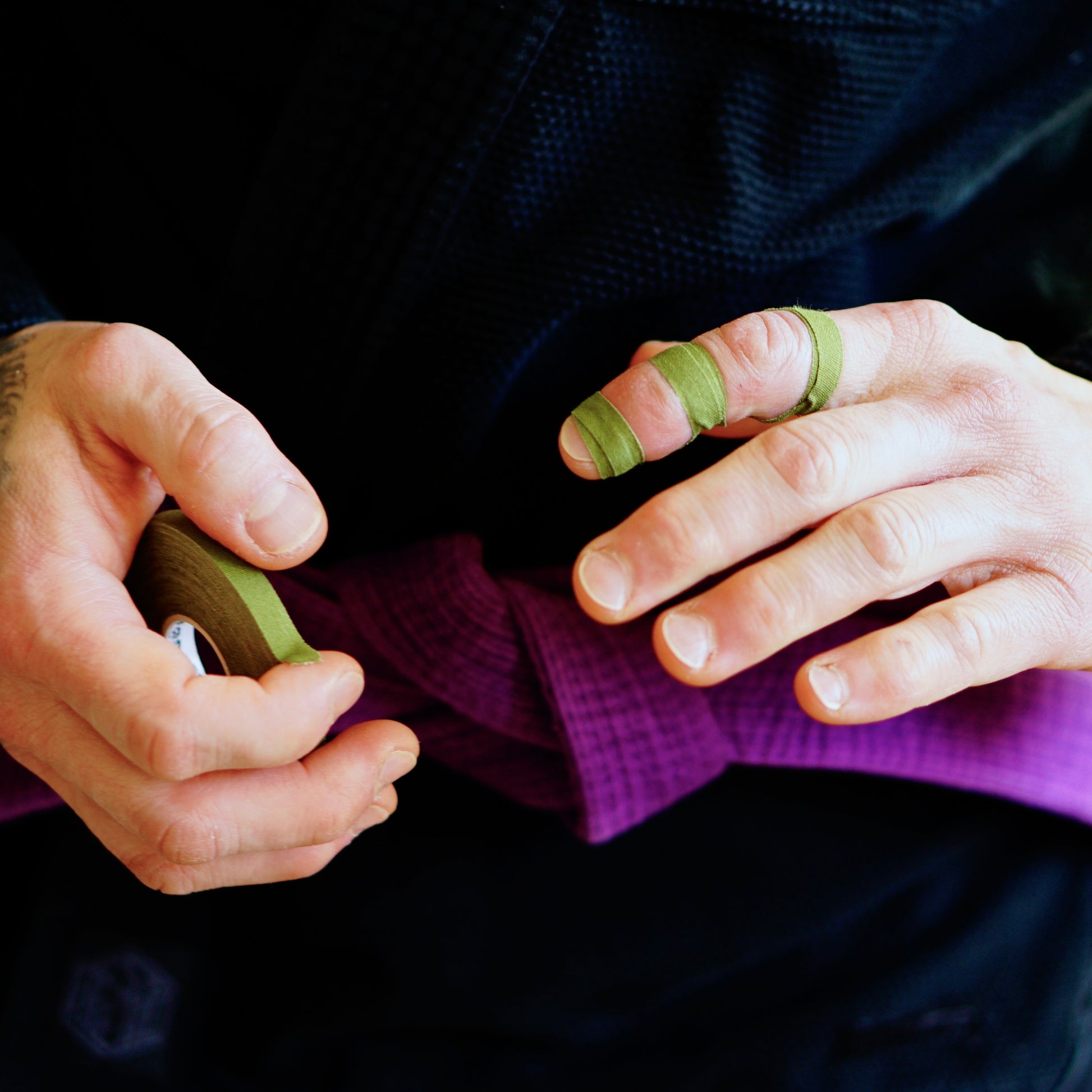 Sticky Grips low stretch BJJ finger tape khaki applied for finger joint support during training
